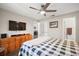 Comfortable bedroom offers wood floors, ceiling fan, and ensuite bathroom access at 3860 Branch Ave, Mount Dora, FL 32757