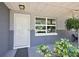 Close up of front door with beautiful plants and large windows with natural light at 3860 Branch Ave, Mount Dora, FL 32757