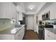 Updated kitchen with granite countertops, stainless steel appliances and bright white cabinets at 3860 Branch Ave, Mount Dora, FL 32757