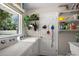 Functional laundry room with washer, dryer, window, and storage shelves at 3860 Branch Ave, Mount Dora, FL 32757