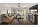 Inviting living room with modern flooring, comfortable seating, and bright light from windows at 3860 Branch Ave, Mount Dora, FL 32757