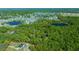 Aerial view featuring mature trees and the neighborhood lakes surround a property at 39636 Carolina Ave, Lady Lake, FL 32159