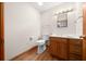 Bathroom featuring a wood vanity with granite countertop and a decorative light fixture at 39636 Carolina Ave, Lady Lake, FL 32159