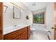Bathroom featuring a vanity and a toilet next to a soaking tub under a large window at 39636 Carolina Ave, Lady Lake, FL 32159