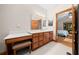 Bathroom has a wood vanity with plenty of storage and dressing table, and adjoins a bedroom at 39636 Carolina Ave, Lady Lake, FL 32159