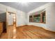 Bedroom features a bay window, hardwood floors and doorway to a bathroom at 39636 Carolina Ave, Lady Lake, FL 32159