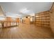 Bonus room featuring wood paneled walls, laminate floor, built in shelving and a window AC unit at 39636 Carolina Ave, Lady Lake, FL 32159