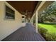 Side of house features a covered porch with a ceiling fan and views of lawn at 39636 Carolina Ave, Lady Lake, FL 32159