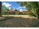 Rear exterior view of home featuring a large yard and covered porch areas at 39636 Carolina Ave, Lady Lake, FL 32159