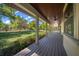 Spacious covered front porch with wood floors overlooking a beautifully landscaped yard at 39636 Carolina Ave, Lady Lake, FL 32159