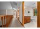Hallway leads to a bathroom with a wood vanity, toilet, and a white bathtub at 39636 Carolina Ave, Lady Lake, FL 32159