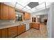 This is a kitchen with wooden cabinets, white appliances, and a tile floor at 39636 Carolina Ave, Lady Lake, FL 32159