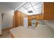 This is a kitchen with wooden cabinets, white appliances, and a tile floor at 39636 Carolina Ave, Lady Lake, FL 32159