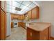 Kitchen features light wood cabinets, recessed lights, neutral countertops, and tile flooring at 39636 Carolina Ave, Lady Lake, FL 32159
