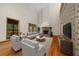 Bright living room with vaulted ceilings, fireplace, hardwood floors, and large windows at 39636 Carolina Ave, Lady Lake, FL 32159