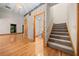 Living room with hardwood floors, staircase and doorway to a half bath at 39636 Carolina Ave, Lady Lake, FL 32159