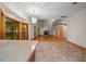 Bright living room with vaulted ceilings, fireplace, hardwood floors, and kitchen in background at 39636 Carolina Ave, Lady Lake, FL 32159