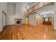 Open living room with high ceilings, a brick fireplace, and hardwood floors at 39636 Carolina Ave, Lady Lake, FL 32159
