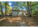 Outbuilding with two garage doors, a side door and trees in the background at 39636 Carolina Ave, Lady Lake, FL 32159