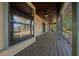 Covered porch featuring wooden flooring, ceiling fans, and views of the yard at 39636 Carolina Ave, Lady Lake, FL 32159