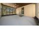 Spacious screened-in porch features steps, a door, and an overhead ceiling fan at 39636 Carolina Ave, Lady Lake, FL 32159