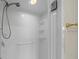 The white tiled shower includes installed shelving, updated fixtures, and a glass enclosure at 39636 Carolina Ave, Lady Lake, FL 32159