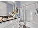 Bright bathroom featuring a modern vanity, decorative mirror, and shower tub, providing a clean and stylish space at 5397 Marshelder St, Apopka, FL 32712