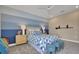 Charming bedroom featuring a cozy bed with a blue and white quilt, complemented by nautical decor and soft lighting at 5397 Marshelder St, Apopka, FL 32712