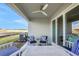 Covered patio features a ceiling fan and contemporary outdoor furniture with a view at 5397 Marshelder St, Apopka, FL 32712