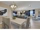 Open dining room with a contemporary chandelier, table, and seating. Kitchen is visible in the background at 5397 Marshelder St, Apopka, FL 32712