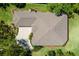 An aerial view of the roof and landscaping shows a large home with an attached garage at 6106 Spinnaker Loop, Lady Lake, FL 32159