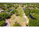 Picturesque aerial view of a golf course community with lush greenery, serene ponds, and beautiful homes at 6106 Spinnaker Loop, Lady Lake, FL 32159