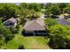 Charming property showcases lush landscaping, a well-maintained lawn, and an inviting screened lanai amidst mature trees at 6106 Spinnaker Loop, Lady Lake, FL 32159