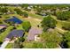 Beautiful home on golf course with mature landscaping and water views from an aerial perspective at 6106 Spinnaker Loop, Lady Lake, FL 32159