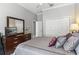 Bedroom featuring a dresser with mirror, closet, and a comfortable bed with stylish pillows at 6106 Spinnaker Loop, Lady Lake, FL 32159