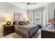 Comfortable bedroom with a large bed, bay window with shutters, and tasteful decor at 6106 Spinnaker Loop, Lady Lake, FL 32159