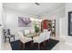 Elegant dining room with modern lighting, glass-top table and seating for six at 6106 Spinnaker Loop, Lady Lake, FL 32159