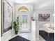 Inviting foyer with marble floors, decorative glass door, and stylish artwork that adds elegance to the home at 6106 Spinnaker Loop, Lady Lake, FL 32159
