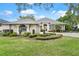 Well-maintained home featuring a manicured lawn, symmetrical landscaping, and a welcoming front entrance at 6106 Spinnaker Loop, Lady Lake, FL 32159