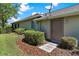 Charming home exterior featuring a convenient side entrance, well-maintained landscaping, and a cozy, inviting atmosphere at 6106 Spinnaker Loop, Lady Lake, FL 32159