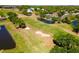Scenic aerial view of the community golf course with ponds, sand traps and lush landscaping at 6106 Spinnaker Loop, Lady Lake, FL 32159