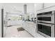 Spacious kitchen features an island, stainless steel appliances and white cabinetry at 6106 Spinnaker Loop, Lady Lake, FL 32159