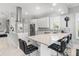 Modern kitchen with a center island, bar seating, white cabinetry, stainless steel appliances, and ample counter space at 6106 Spinnaker Loop, Lady Lake, FL 32159