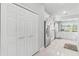 Well-lit kitchen features stainless steel refrigerator, white cabinets, and marble floors at 6106 Spinnaker Loop, Lady Lake, FL 32159