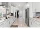 Bright, open kitchen boasts stainless steel appliances and pristine white cabinetry and countertop at 6106 Spinnaker Loop, Lady Lake, FL 32159