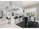 Bright, open kitchen featuring white cabinets, marble floors, stainless steel appliances, and an adjacent dining area at 6106 Spinnaker Loop, Lady Lake, FL 32159