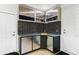 Modern laundry room featuring sleek cabinetry, stylish backsplash, and convenient sink area at 6106 Spinnaker Loop, Lady Lake, FL 32159