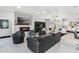 Expansive living area with contemporary fireplace, plenty of seating, and view to the kitchen and dining areas at 6106 Spinnaker Loop, Lady Lake, FL 32159