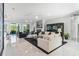 Open-concept living room with marble floors, fireplace, and comfortable seating, perfect for relaxation and entertainment at 6106 Spinnaker Loop, Lady Lake, FL 32159