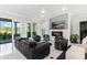 Spacious living room with fireplace, providing access to outdoor patio with seating and views of the surrounding landscape at 6106 Spinnaker Loop, Lady Lake, FL 32159
